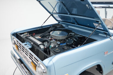 1973 Ford Bronco in Brittany Blue over Whiskey leather engine angle