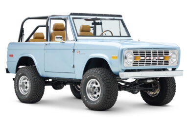 1973 Ford Bronco in Brittany Blue over Whiskey leather passenger front angle