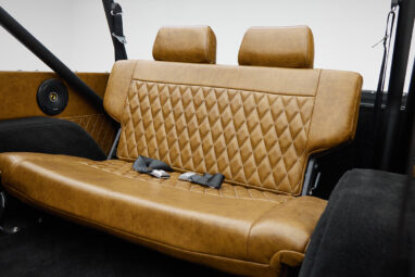 1973 Ford Bronco in Brittany Blue over Whiskey leather back seat