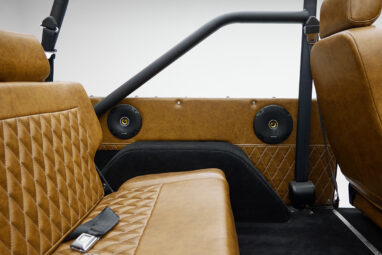 1973 Ford Bronco in Brittany Blue over Whiskey leather rear speaker panel