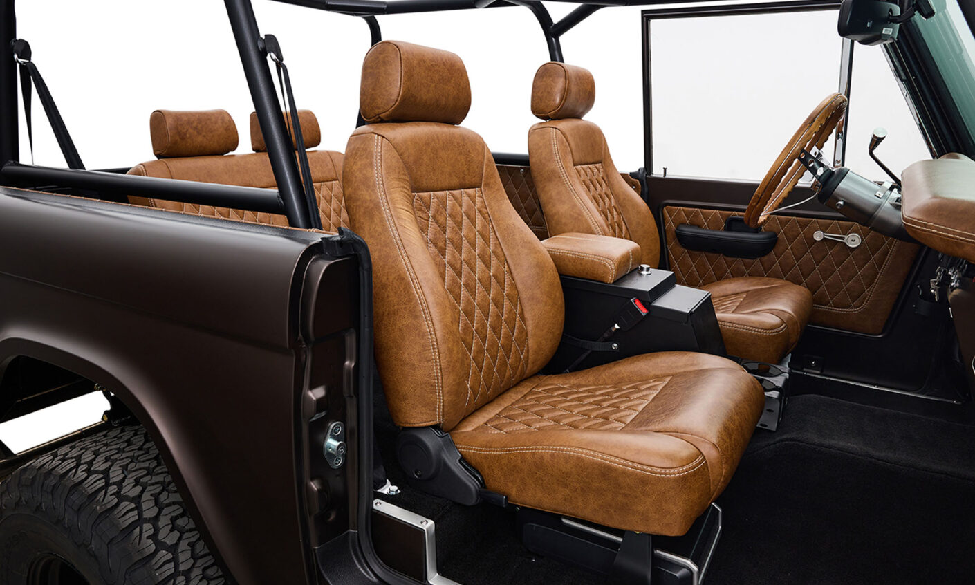 Ford Bronco 1970 in Matte Macadamia Brown with whiskey leather interior and black wheels diamond stitch