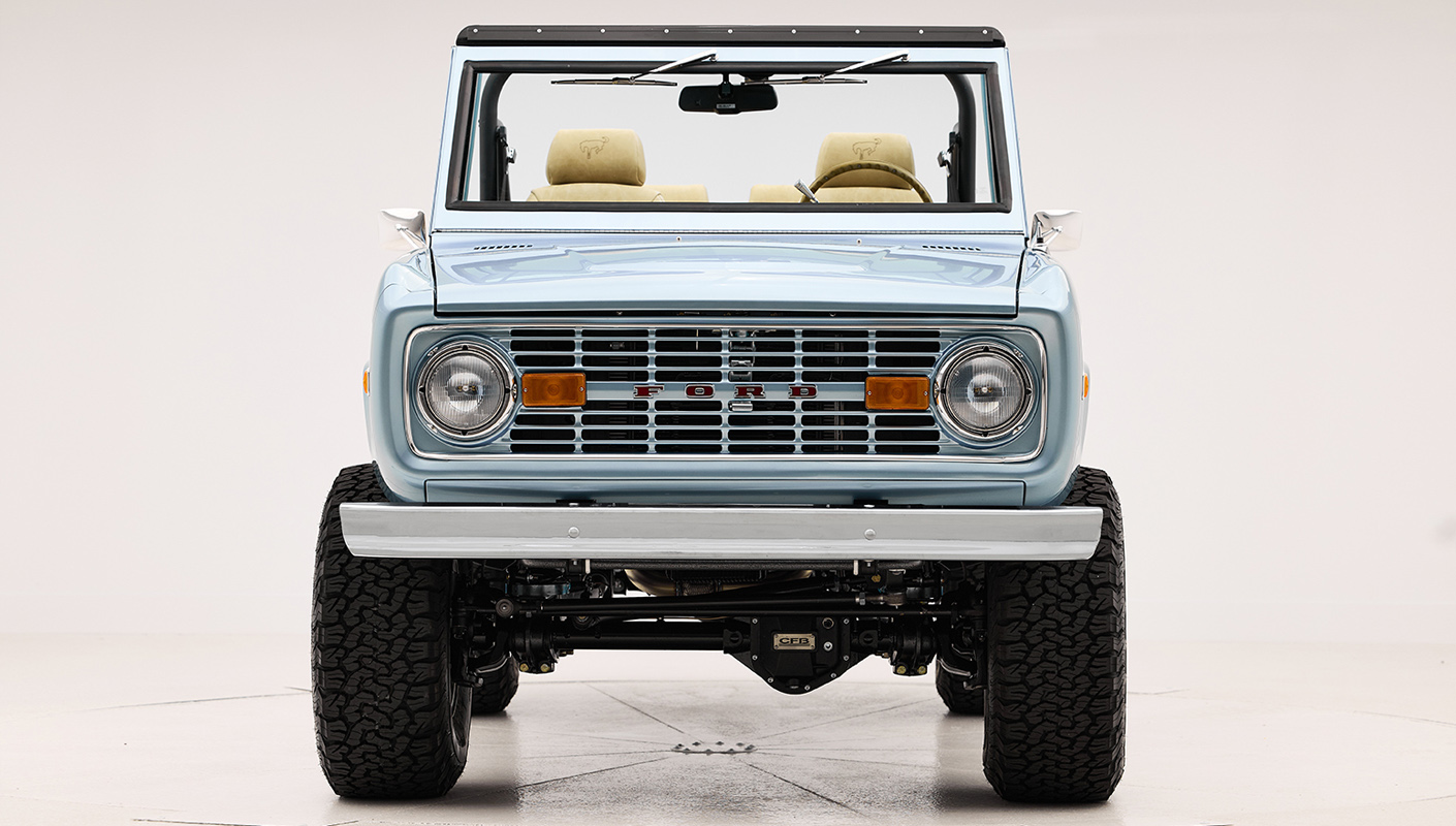 1966 Brittany Blue Classic Ford Bronco with custom diamond stitch interior and color matched grill