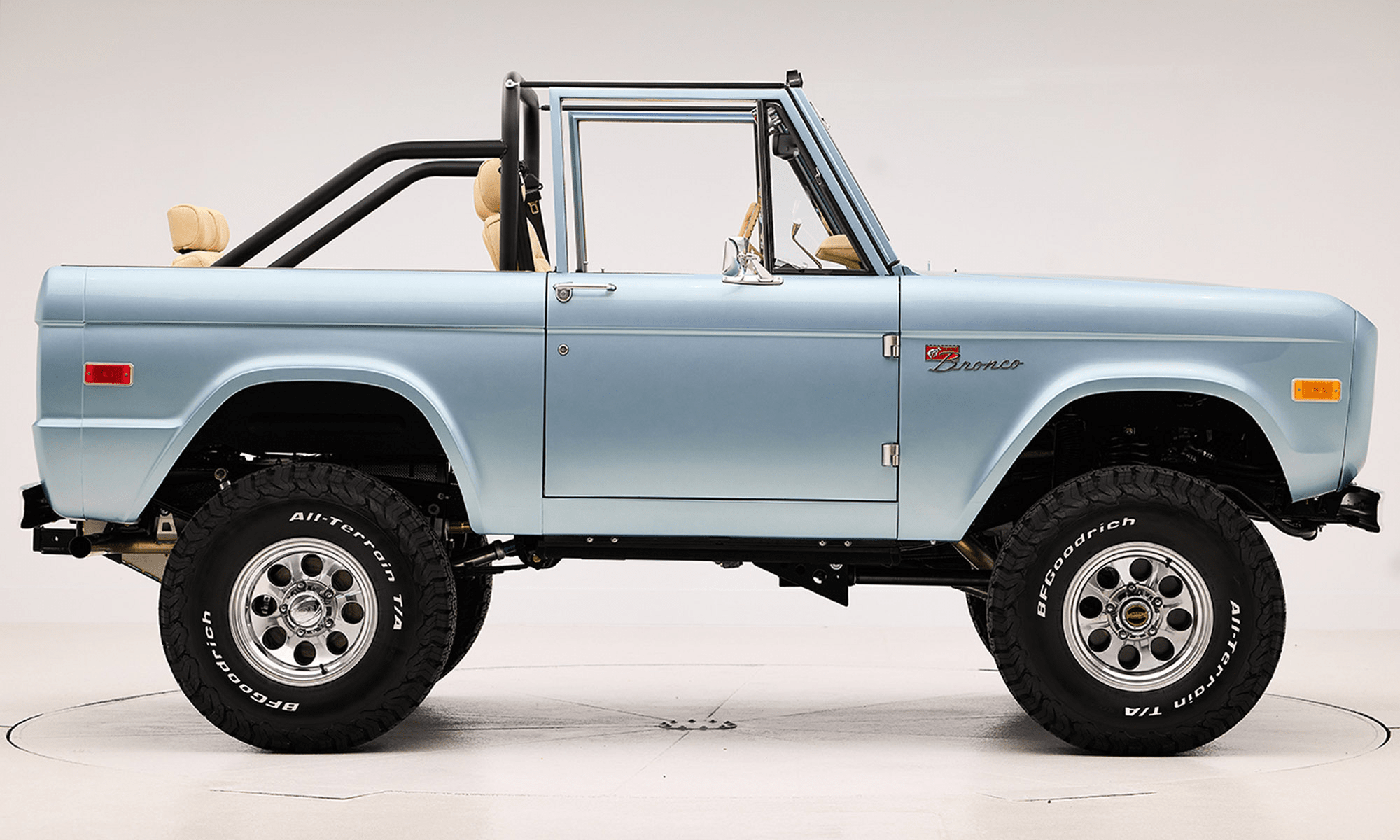 1966 Brittany Blue Classic Ford Bronco with custom diamond stitch interior and factory roll cage