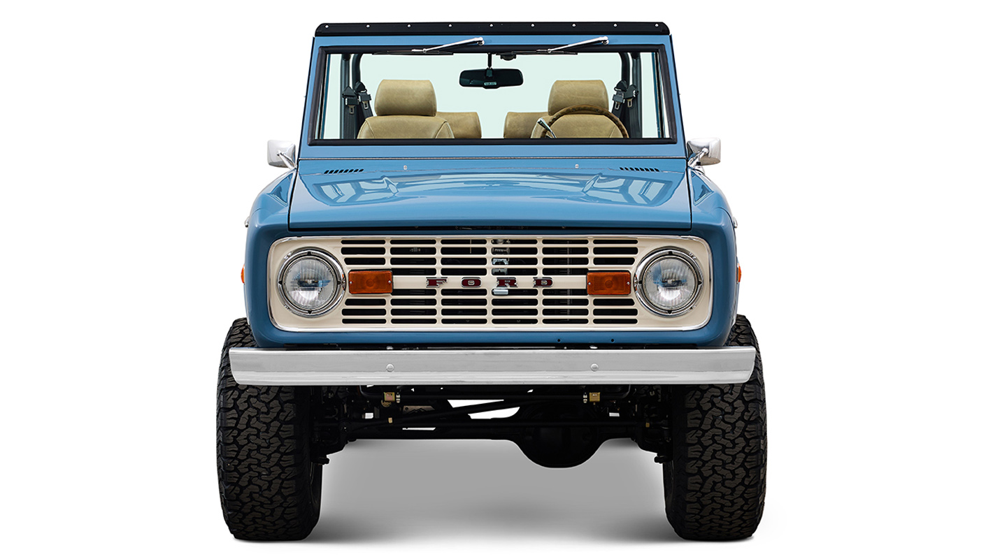 1970 Ford Bronco in Stars and Stripes Blue with family roll cage and Wimbledon White Grille