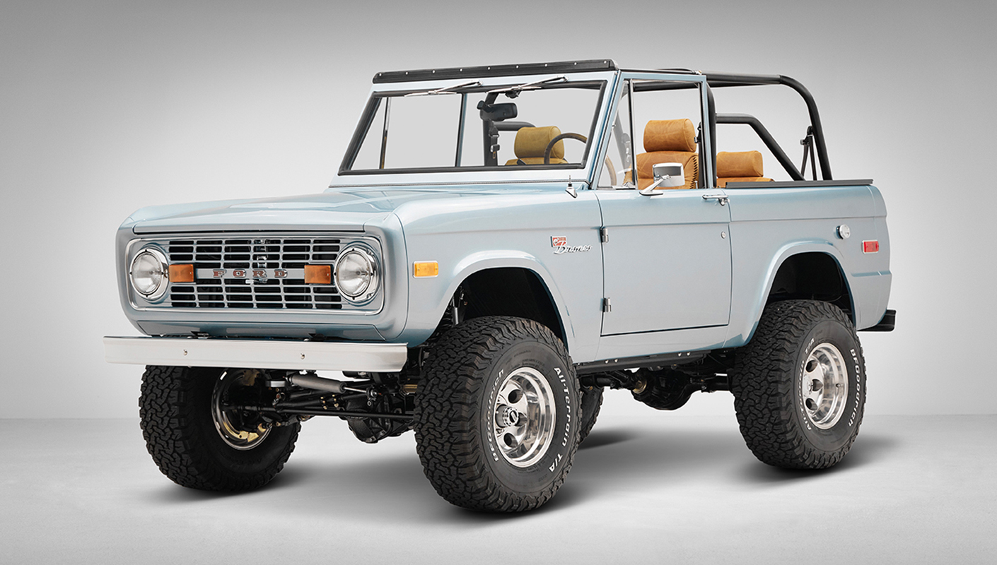 1975 ford bronco painted brittany blue with cowboy debossed, baseball stitch leather front driver angle