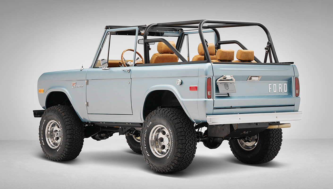 1975 ford bronco painted brittany blue with cowboy debossed, baseball stitch leather rear driver angle