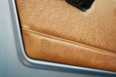 1975 ford bronco painted brittany blue with cowboy debossed, baseball stitch leather detail door panel