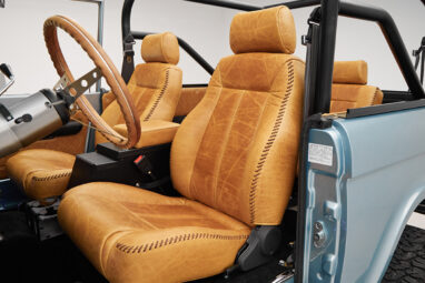 1975 ford bronco painted brittany blue with cowboy debossed, baseball stitch leather driver seat