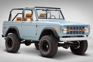 1976 Ford Bronco in Brittany Blue with whiskey diamond stitch passenger front angle