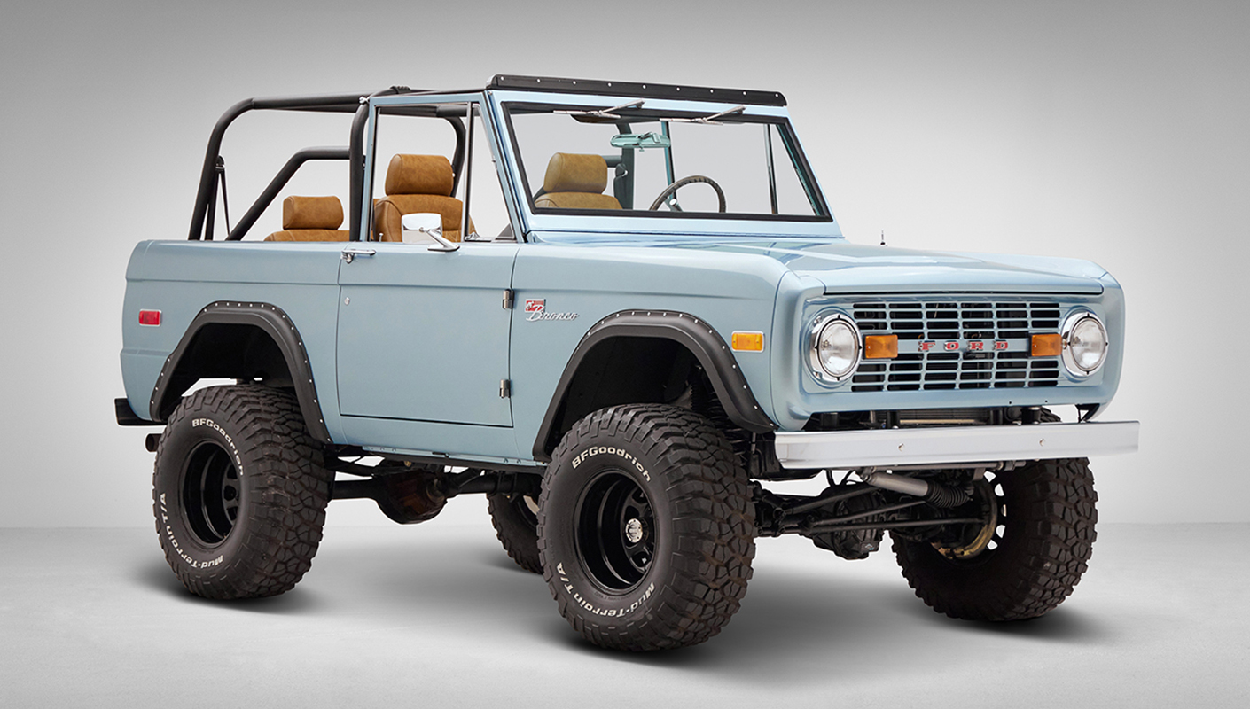 1976 Ford Bronco in Brittany Blue with whiskey diamond stitch passenger front angle