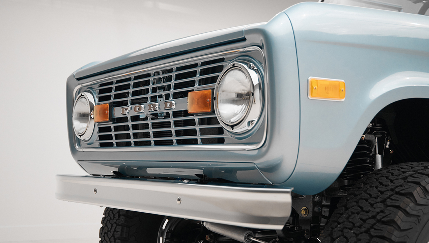 1975 ford bronco painted brittany blue with cowboy debossed, baseball stitch leather grill