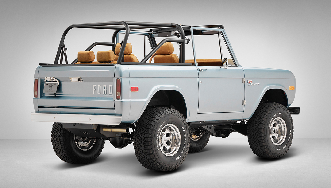 1975 ford bronco painted brittany blue with cowboy debossed, baseball stitch leather rear passenger angle