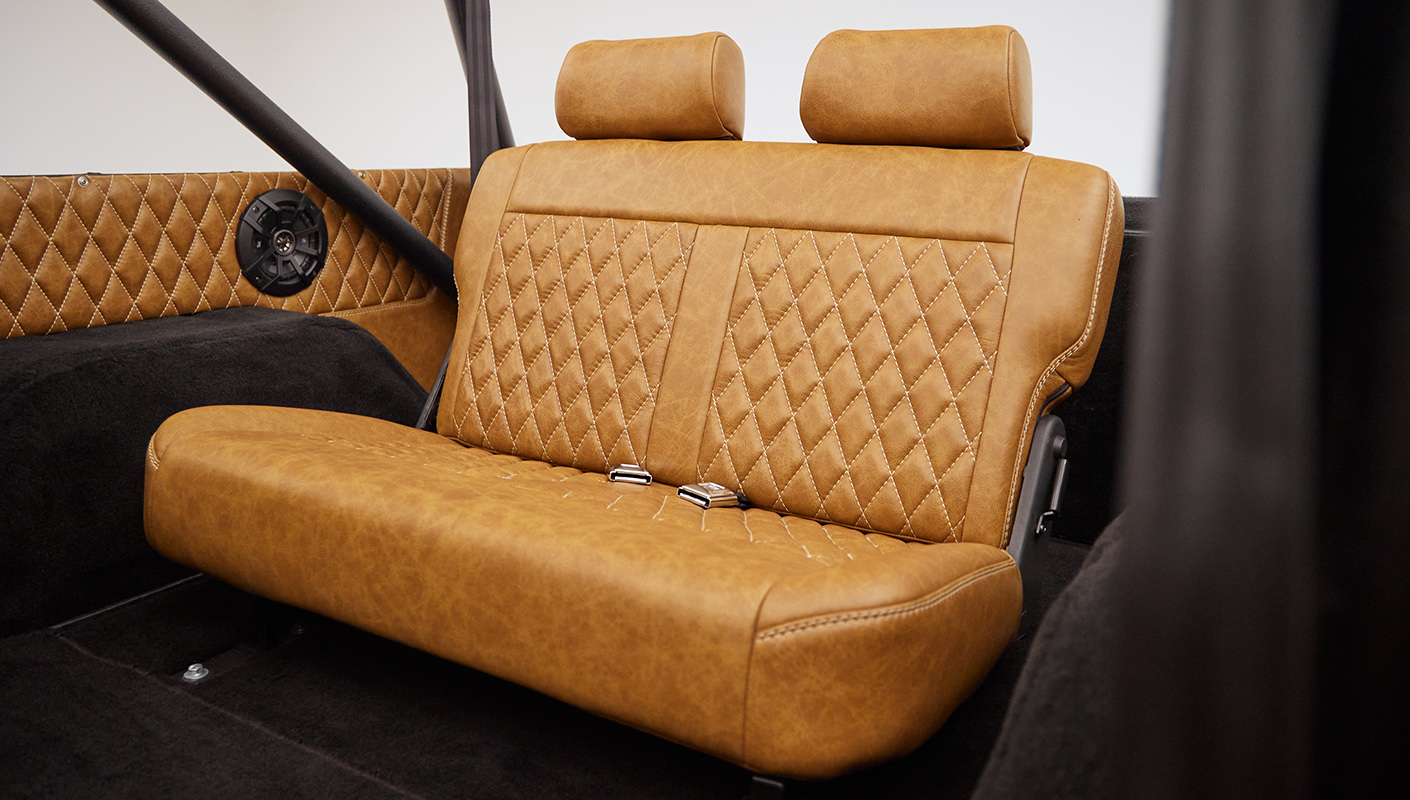 1976 Ford Bronco in Brittany Blue with whiskey diamond stitch leather rear seat