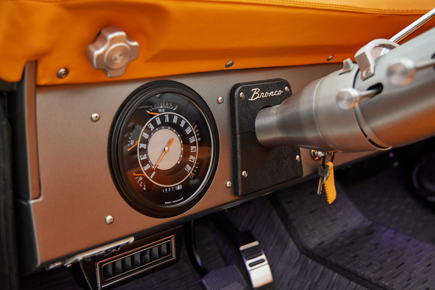 1972 classic ford bronco in matte silver with orange leather interior gauges