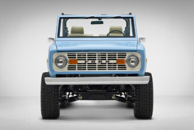 A 1976 Classic Ford Bronco is Frozen Blue over White Rock leather front view