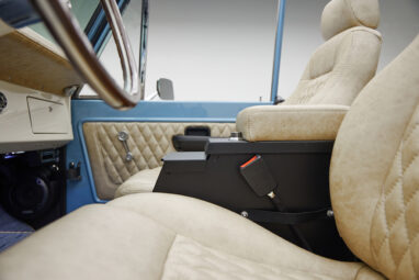 A 1976 Classic Ford Bronco is Frozen Blue over White Rock leather console