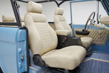 A 1976 Classic Ford Bronco is Frozen Blue over White Rock leather passenger seat