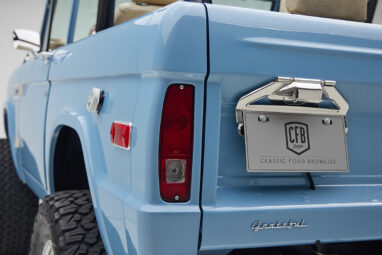 A 1976 Classic Ford Bronco is Frozen Blue over White Rock leather license plate