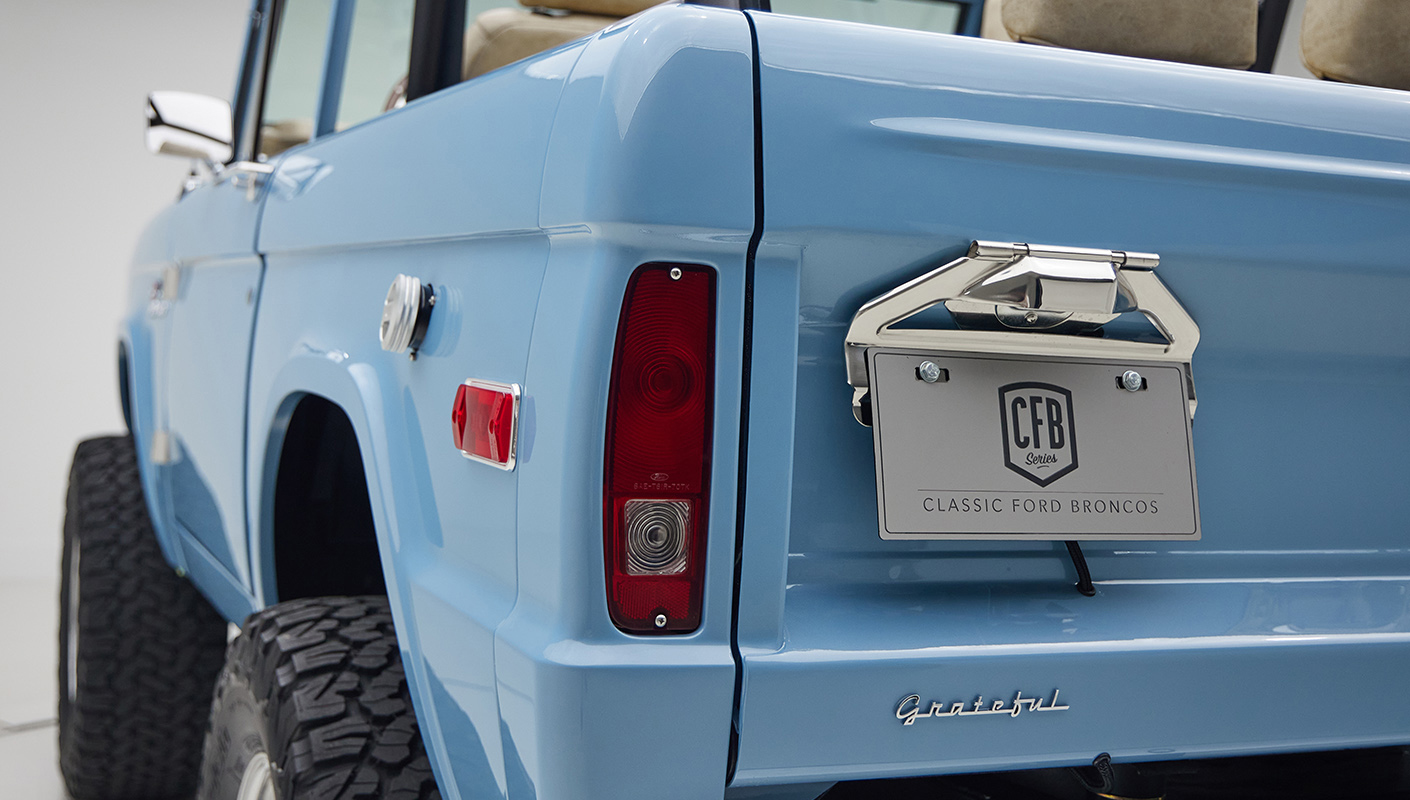 A 1976 Classic Ford Bronco is Frozen Blue over White Rock leather license plate