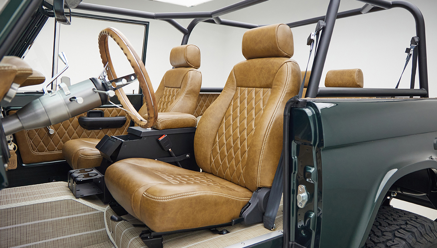 1966 ford bronco in highland green with whiskey leather interior driver seat