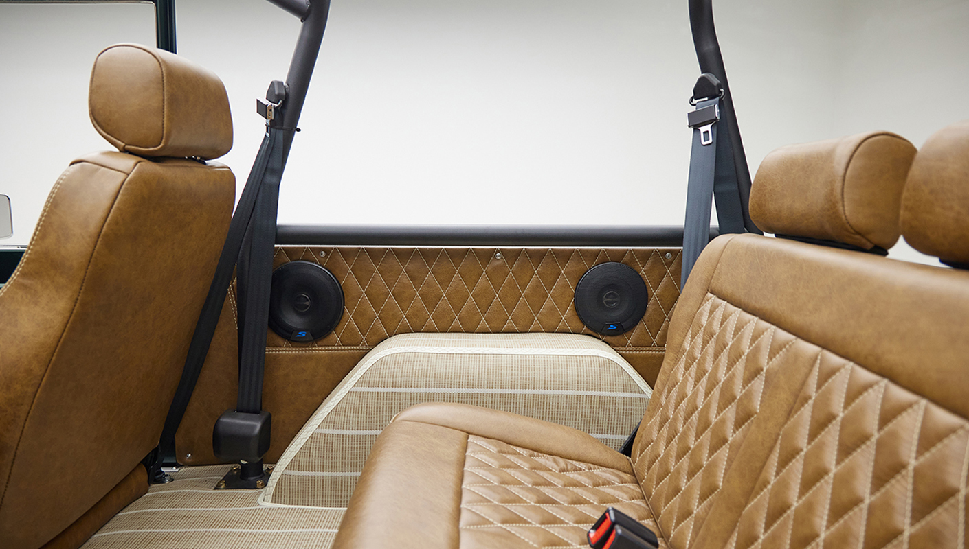 1966 ford bronco in highland green with whiskey leather interior rear seat panel