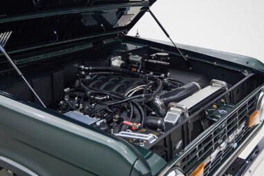 1966 ford bronco in highland green with whiskey leather interior motor angle