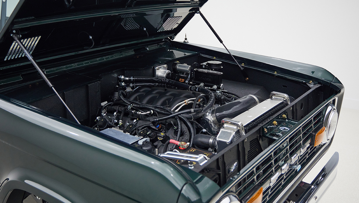 1966 ford bronco in highland green with whiskey leather interior motor angle