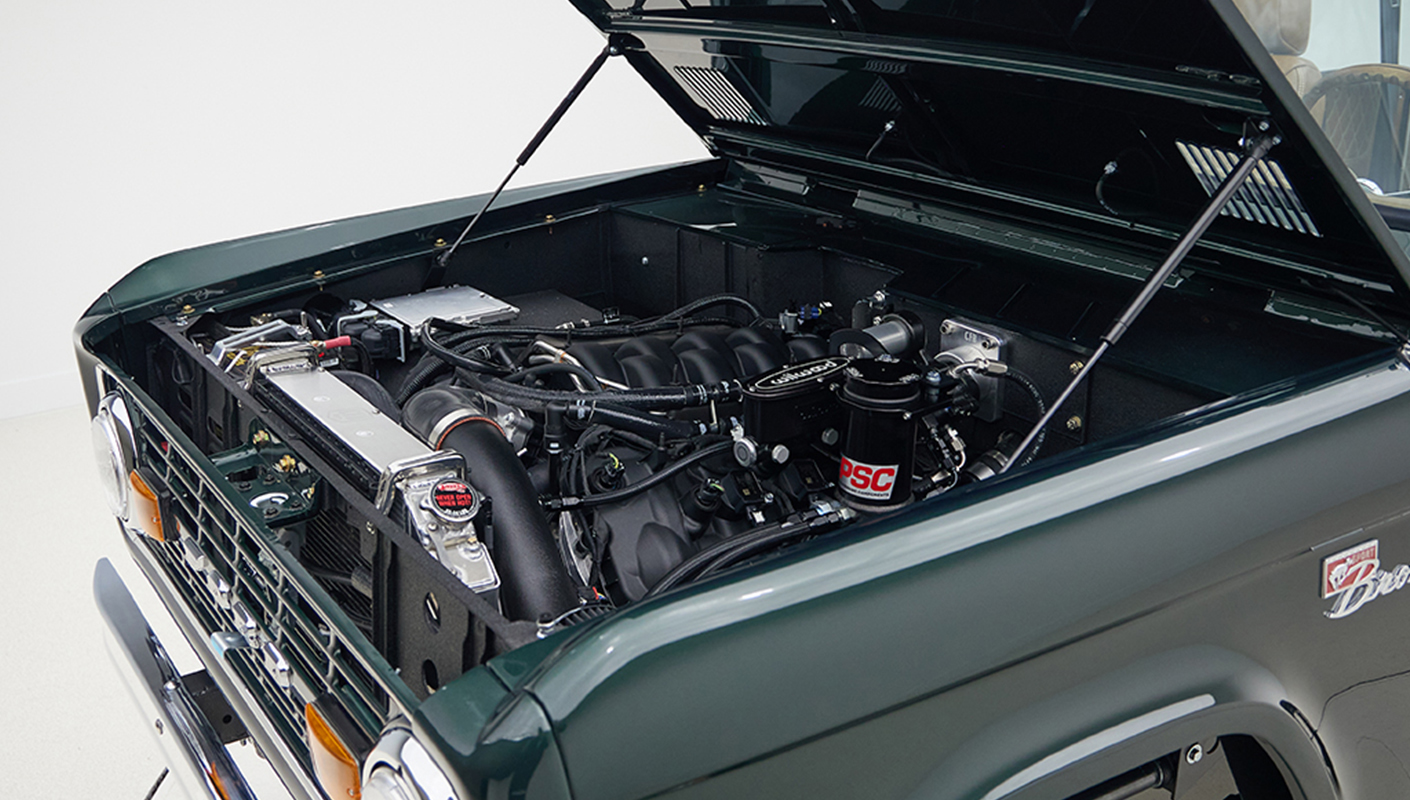 1966 ford bronco in highland green with whiskey leather interior motor angle