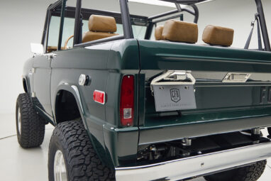 1966 ford bronco in highland green with whiskey leather interior rear angle