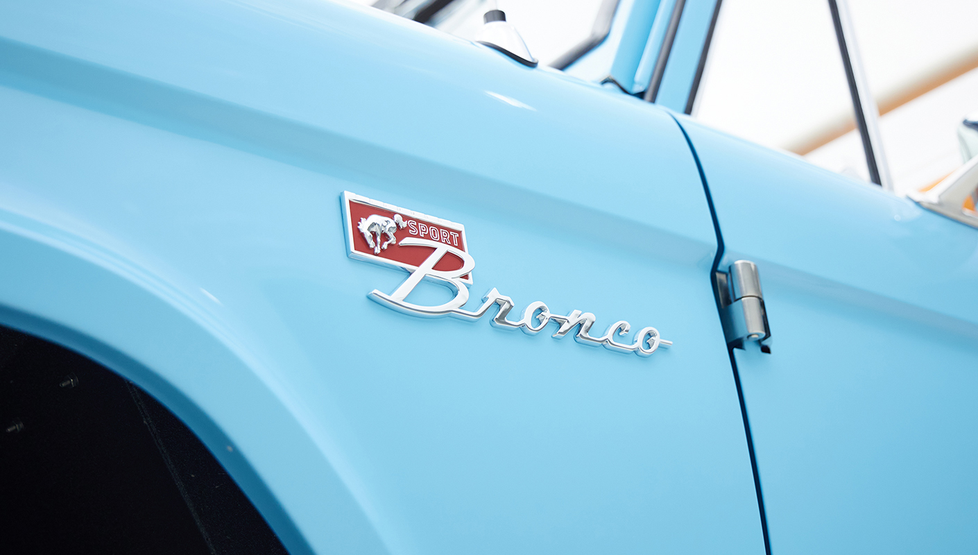 1973 Classic Ford Bronco in frozen blue with rolls royce orange leather and alpaca interior emblem