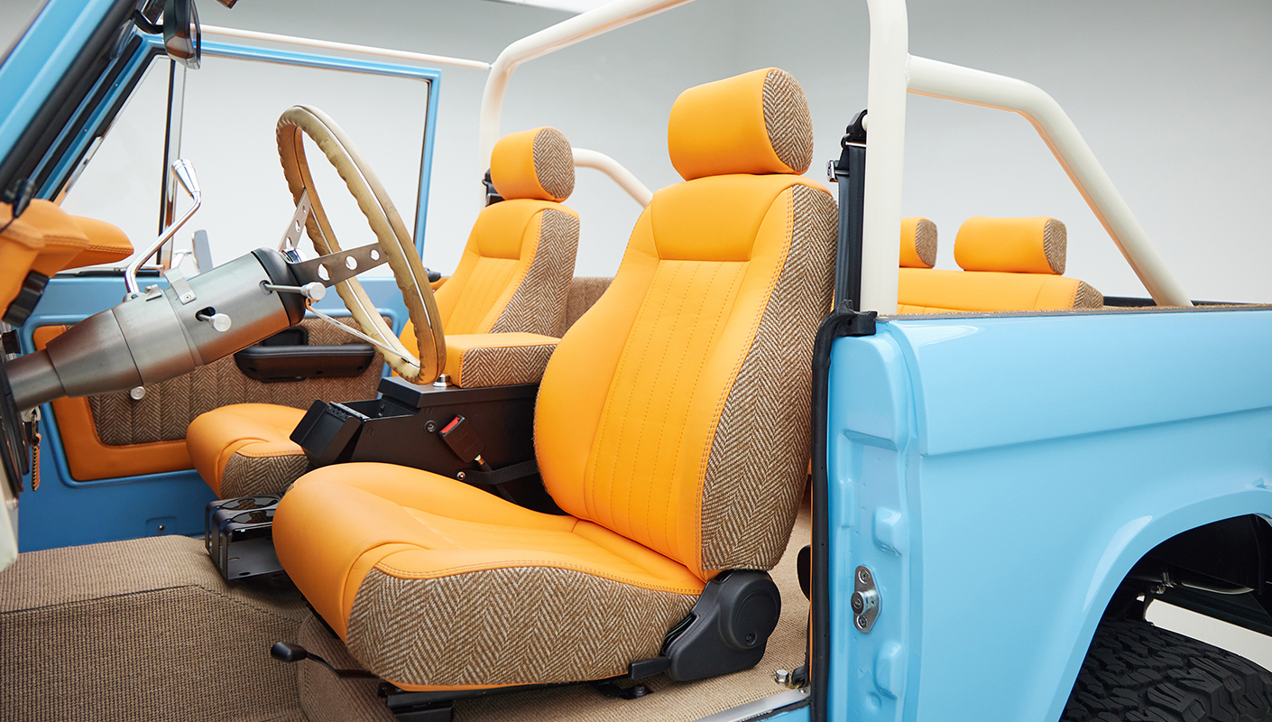 1973 Classic Ford Bronco in frozen blue with rolls royce orange leather and alpaca interior driver seat