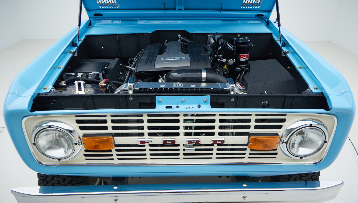 1973 Classic Ford Bronco in frozen blue with rolls royce orange leather and alpaca interior motor front