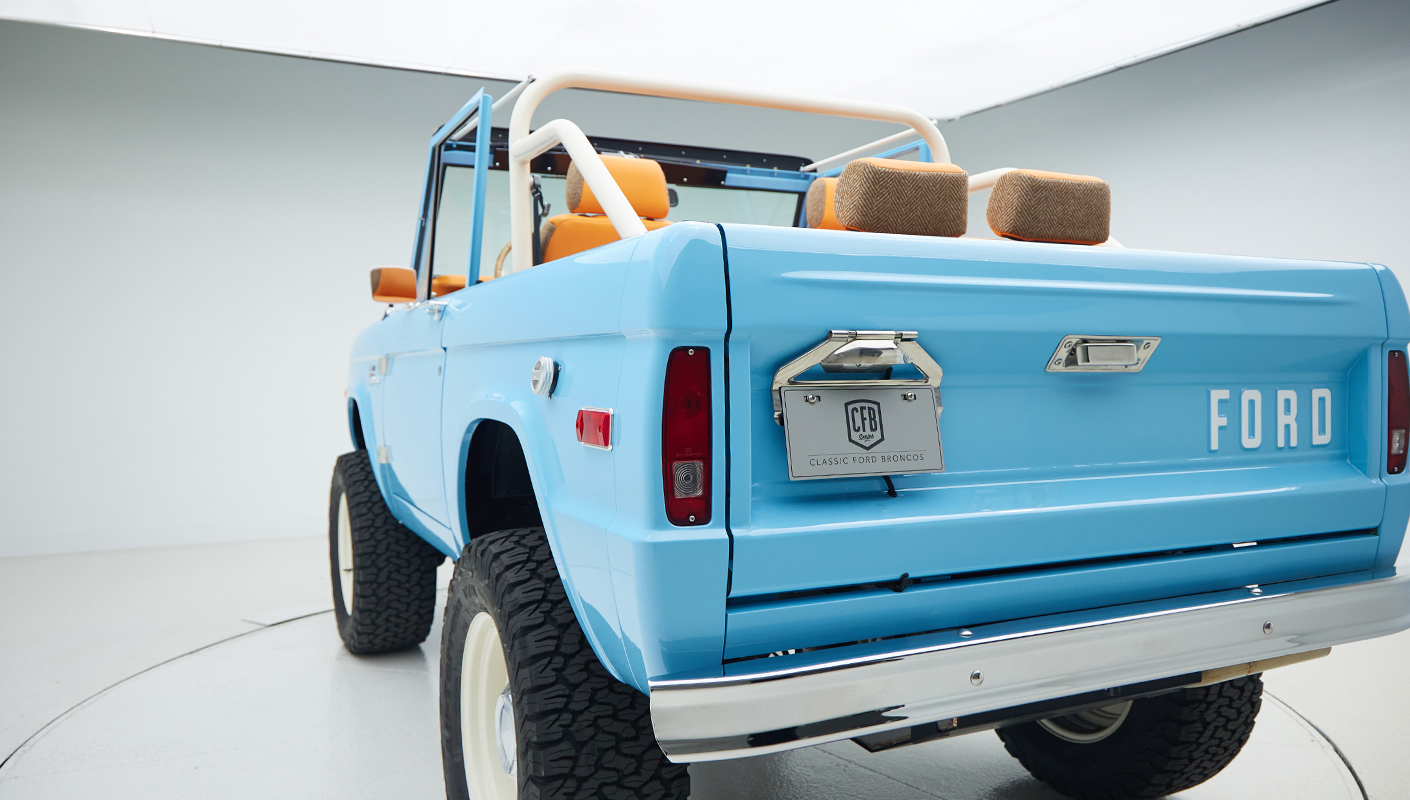 1973 Classic Ford Bronco in frozen blue with rolls royce orange leather and alpaca interior rear angle