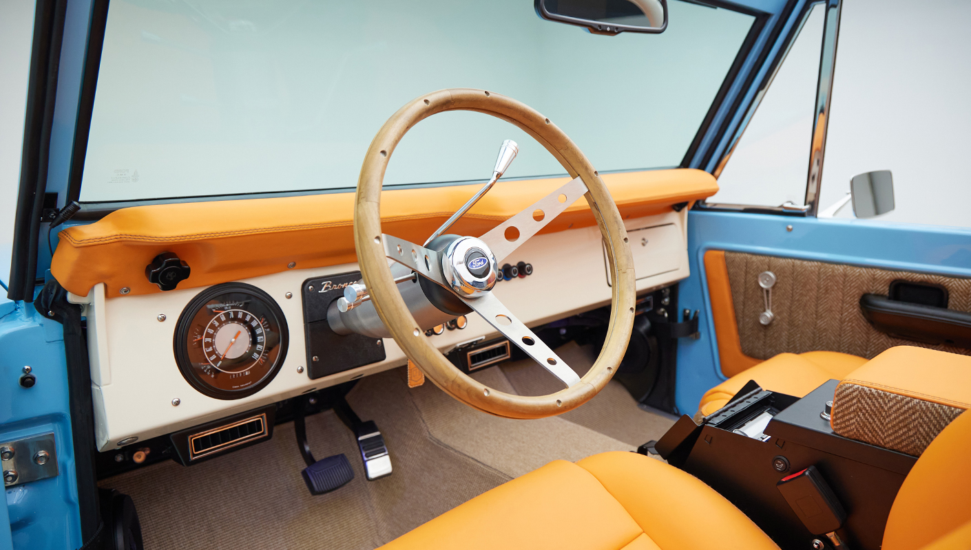 1973 Classic Ford Bronco in frozen blue with rolls royce orange leather and alpaca interior steering wheel