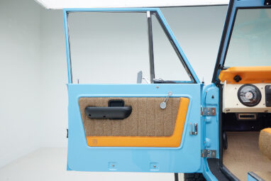 1973 Classic Ford Bronco in frozen blue with rolls royce orange leather and alpaca interior door