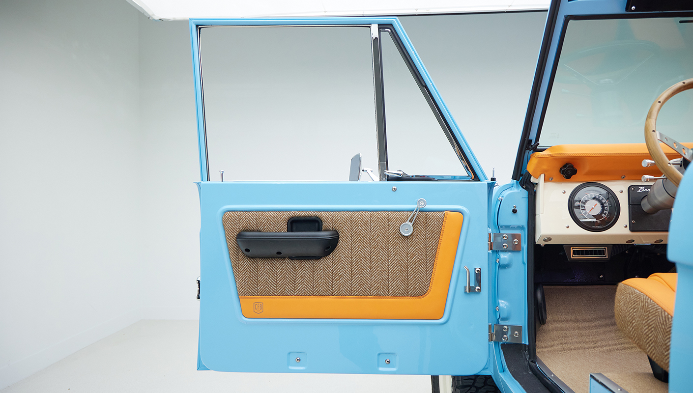 1973 Classic Ford Bronco in frozen blue with rolls royce orange leather and alpaca interior door