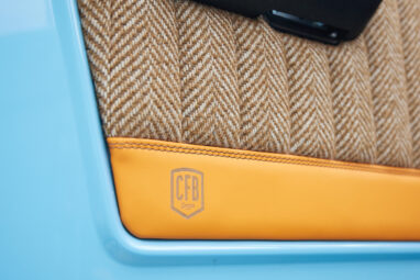 1973 Classic Ford Bronco in frozen blue with rolls royce orange leather and alpaca interior door panel