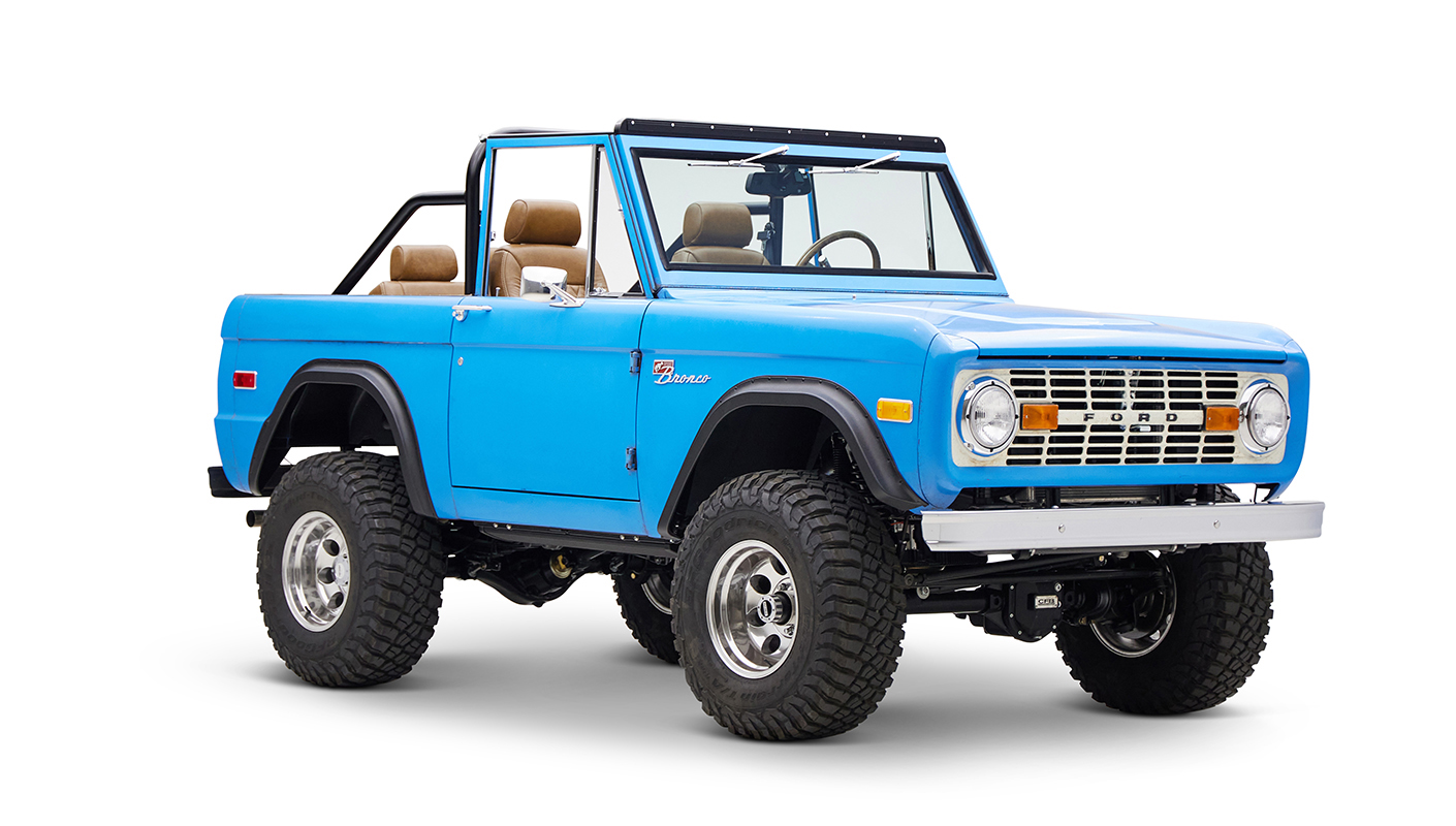1976 classic ford bronco in blue patina paint with whiskey leather interior passenger front angle