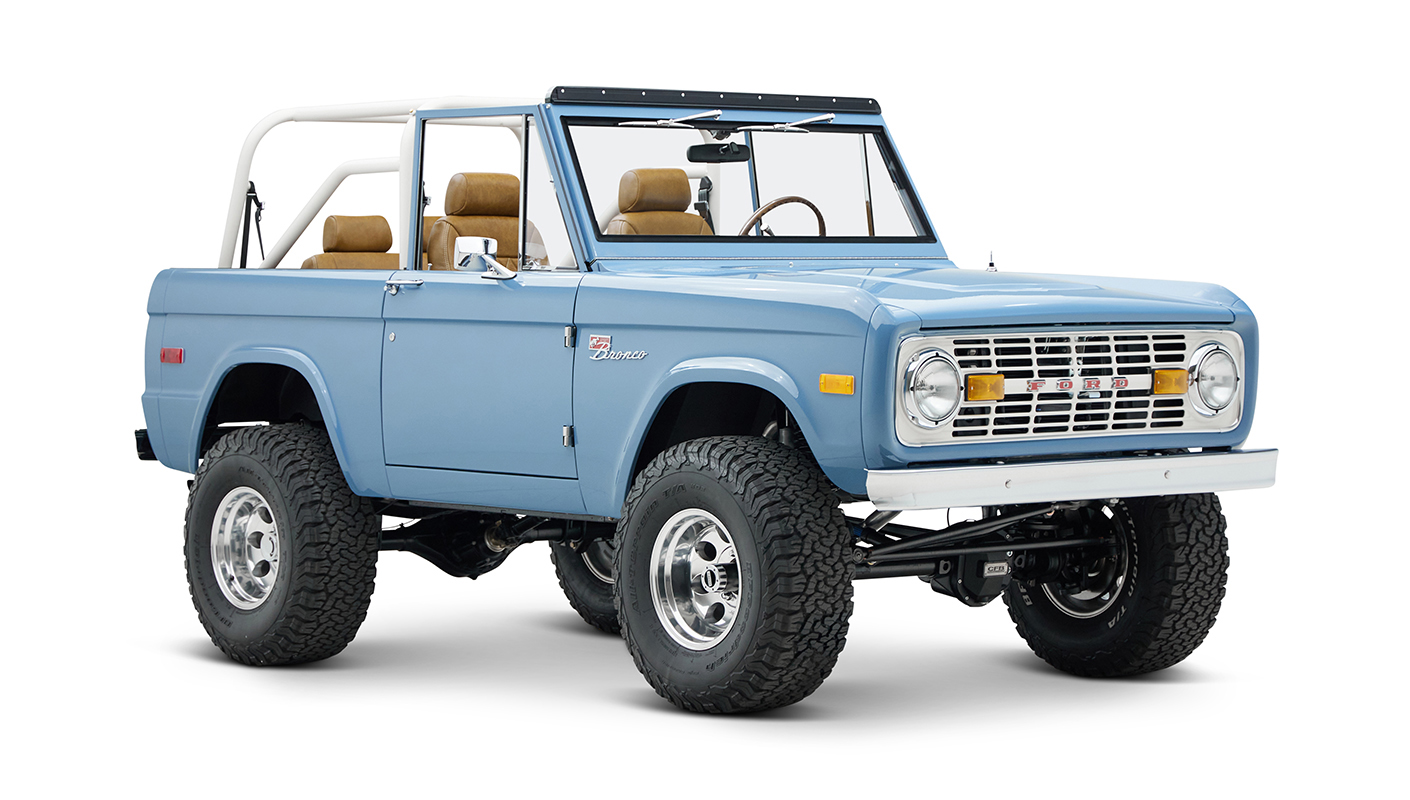 1974 classic ford bronco in stars & stripes blue with whiskey leather passenger front angle